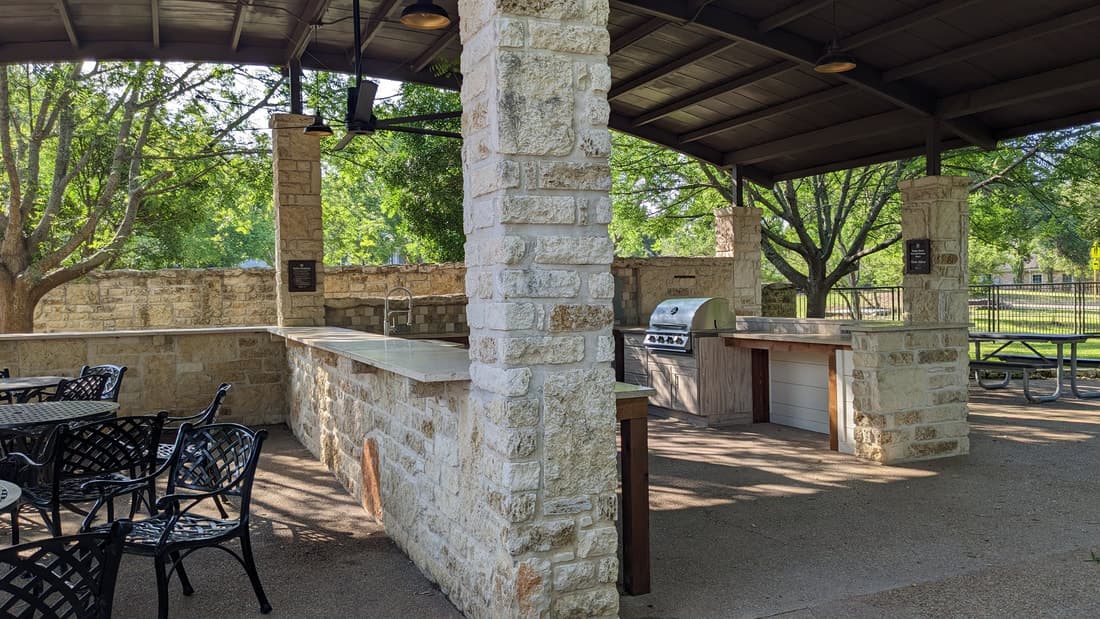 Pool, kitchen and covered patio built as one connected space.